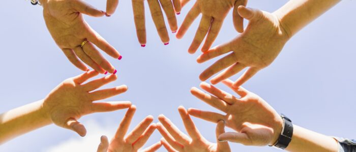 crop-hands-stacked-together-circle-min